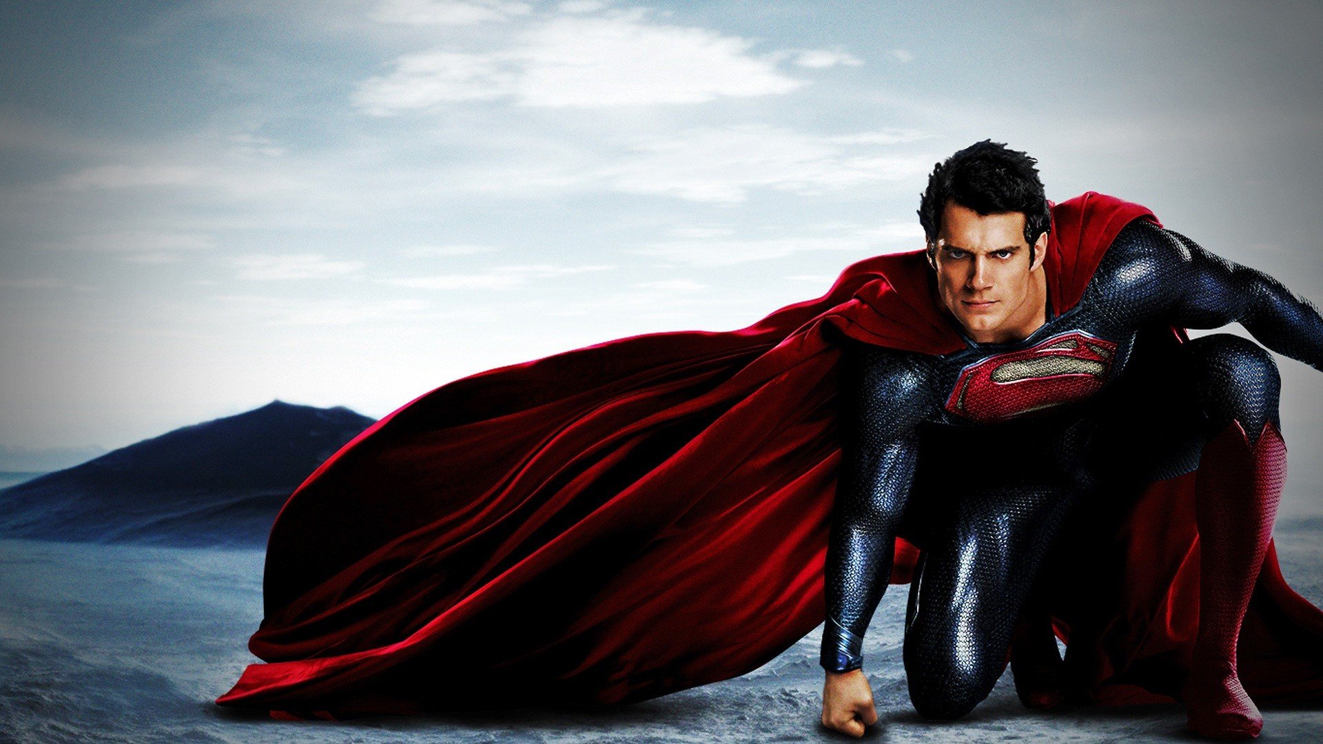 Henry Cavill as Superman in a dramatic pose, wearing the iconic red and blue suit.